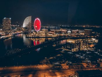 Aerial view of illuminated buildings in city at night