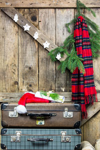 Christmas decorations against wooden wall