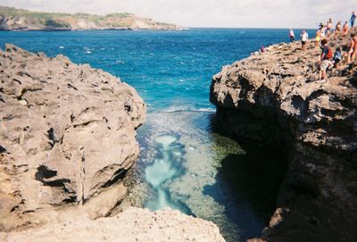 Scenic view of rocks on beach against sky