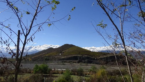 Scenic view of mountains against clear blue sky