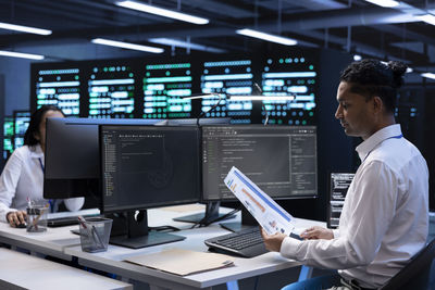 Midsection of businessman working at office