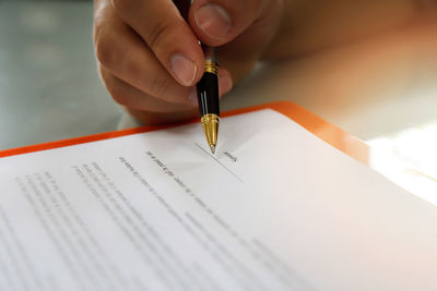 Close-up of human hand holding paper