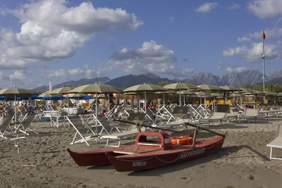 Boats moored on beach against sky