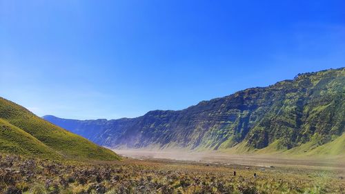 Scenic view of mountains against clear blue sky