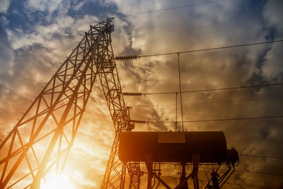 Low angle view of electricity pylon against sky