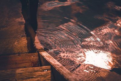 Wooden staircase leading towards water during sunset