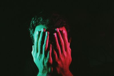 Close-up of hands over black background