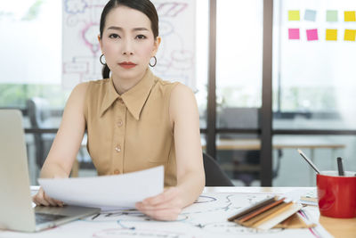 Portrait of a serious young woman using smart phone