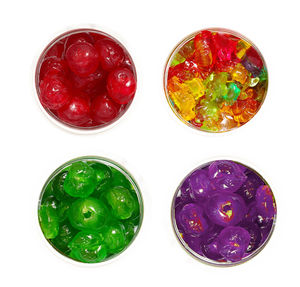 Directly above shot of multi colored candies in glass against white background