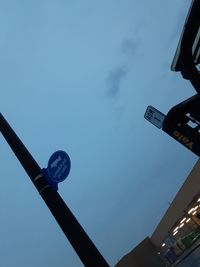 Low angle view of road sign against sky