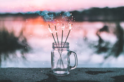 Close-up of fireworks in jar on retaining wall