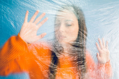 Thoughtful teenage girl trapped in plastic