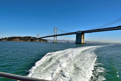 View of bridge over calm sea