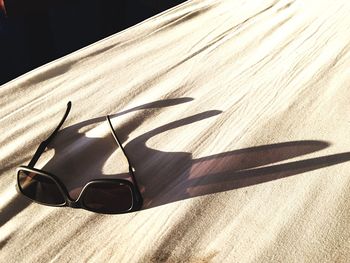 Close-up of sunglasses on blanket