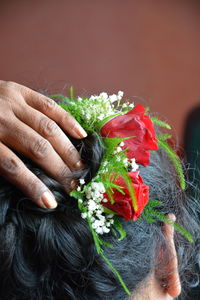 Cropped image of hand holding flower