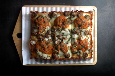 High angle view of detroit style pizza served in wooden board