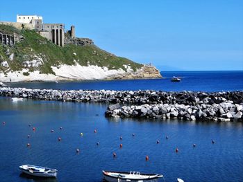 Scenic view of sea against clear blue sky