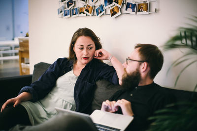 Young couple sitting in front of woman