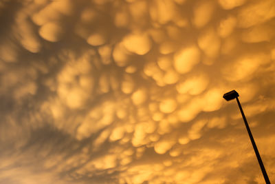 Low angle view of silhouette street light against sky during sunset