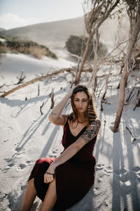 Portrait of woman sitting in snow