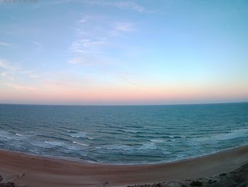 Scenic view of sea against clear sky at sunset