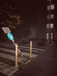 Road sign on street in city at night