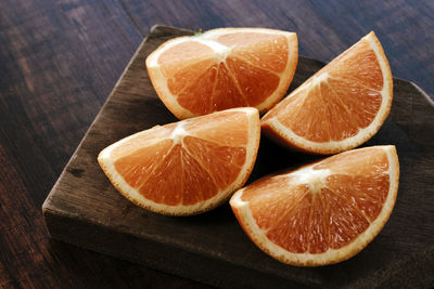 Close-up of orange slices on cutting board