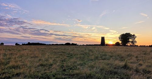 Scenic view of field against sky during sunset