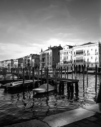 Boats in canal against buildings in city