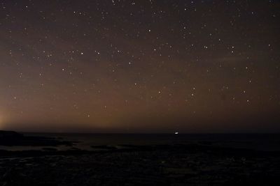 Scenic view of sea against sky at night