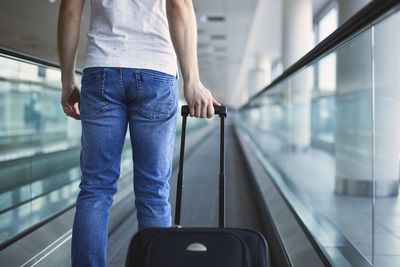 Midsection of man using mobile phone