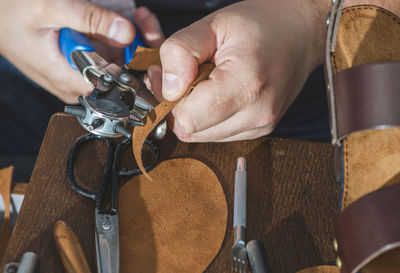 Close-up of shoemaker making sandal at workshop