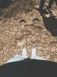 Low section of person standing on cobblestone