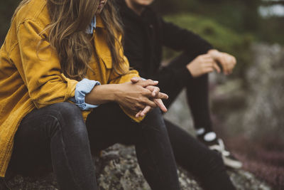 Mid section of woman sitting