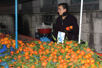 Full length of man standing at market stall