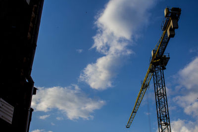 Low angle view of crane against sky