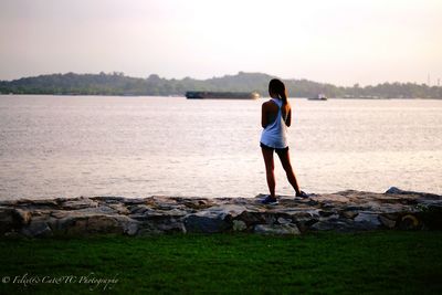 Rear view of woman standing on grass