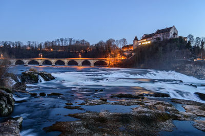 Bridge over river against sky during winter