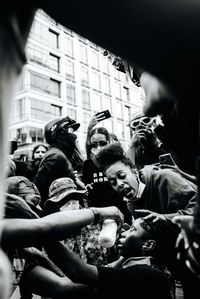Low angle view of people on street at night