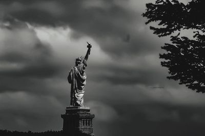 Statue of liberty against cloudy sky