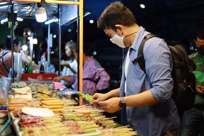 Man standing at market stall