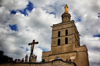 Low angle view of church against cloudy sky