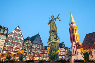 Scales of justice at romerberg square, the romer, with the old nikolai church, frankfurt, germany