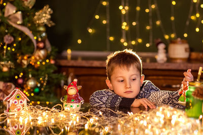 Portrait of girl in illuminated christmas tree