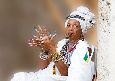 Senior woman wearing traditional clothing smoking cigar
