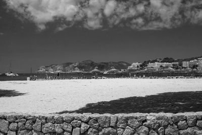 Scenic view of beach by sea against sky