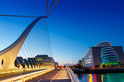 View of suspension bridge against blue sky