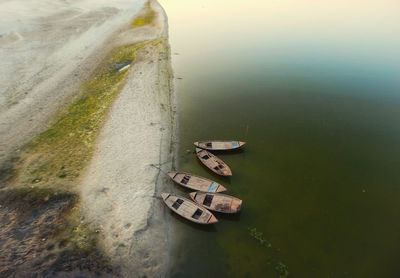 High angle view of boats moored at lakeshore