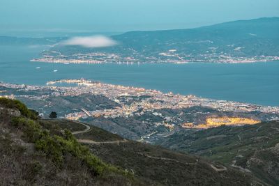 High angle view of sea and city against sky