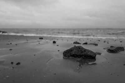 Close-up of sand on beach against sky